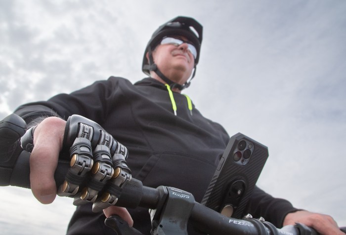 Man with Partial hand prosthetic holding handle of bike.