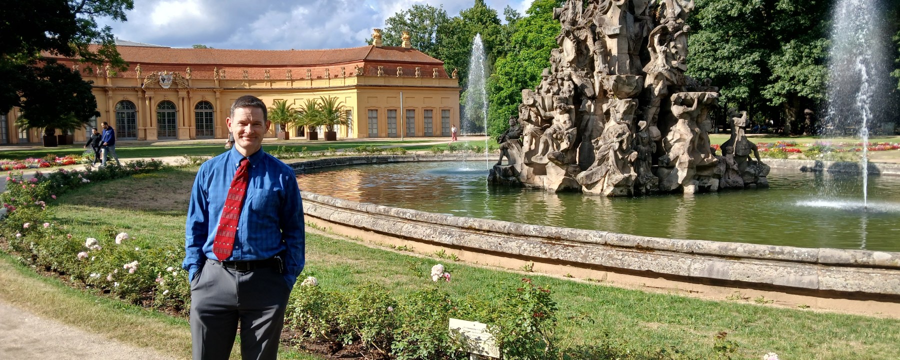 Dr. David Mays in front of a fountain at FAU