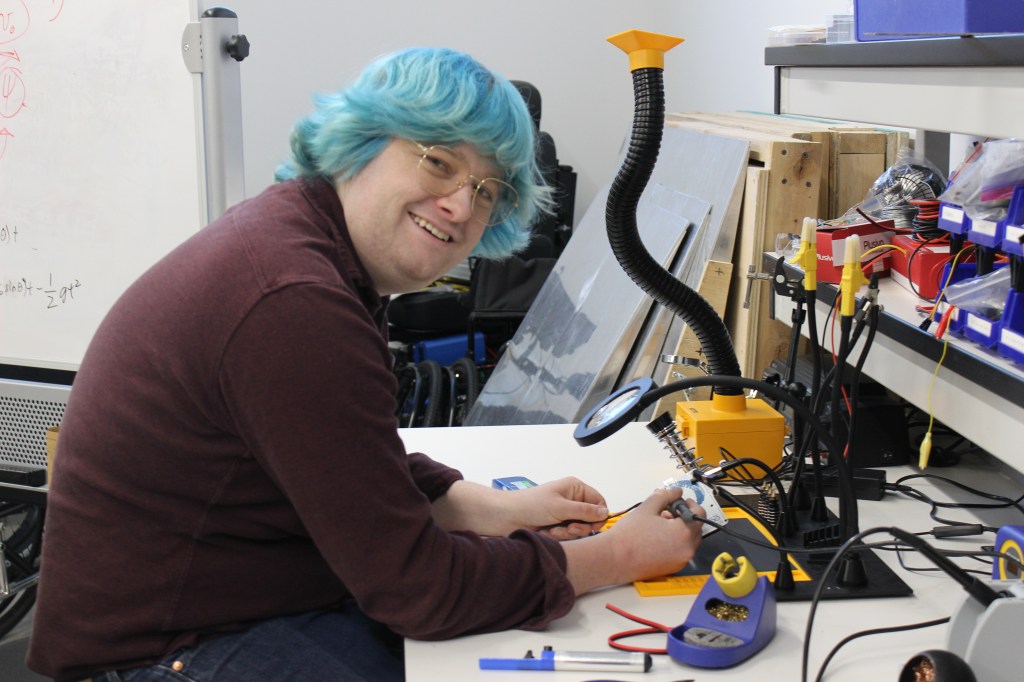 Jack Lueck looking up and smiling from his work