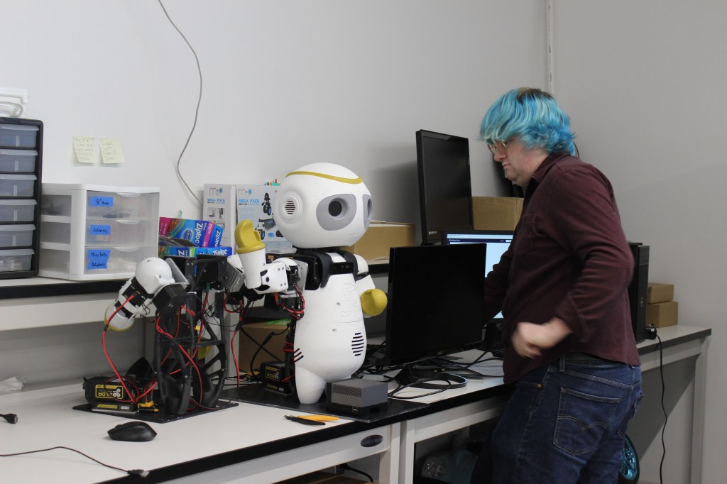 Jack Lueck with a social assistive robot he is working on.